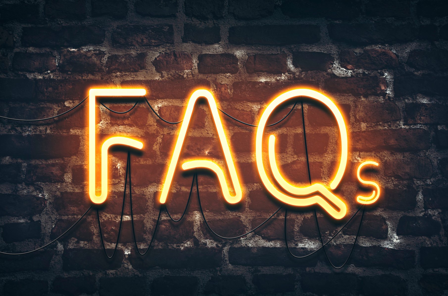 neon faqs sign on brick wall